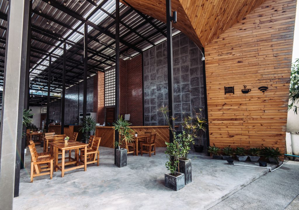 Beautiful modern interior and exterior of accommodation for travelers and backpackers in beach area where mostly young people stay for relaxing holiday. Architecture is mixture of concrete, wood, steel and glass, with open space concept. Property is made of eco-friendly materials.